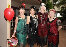 Celia Young, Pat Reinhart, Ina Goldberg and Sherry Wheeler channel their inner flapper style for the Great Gatsby-inspired Poinsettia Luncheon.