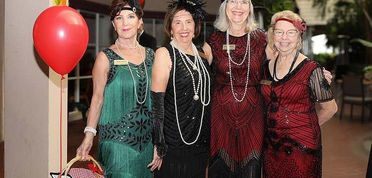 Celia Young, Pat Reinhart, Ina Goldberg and Sherry Wheeler channel their inner flapper style for the Great Gatsby-inspired Poinsettia Luncheon.