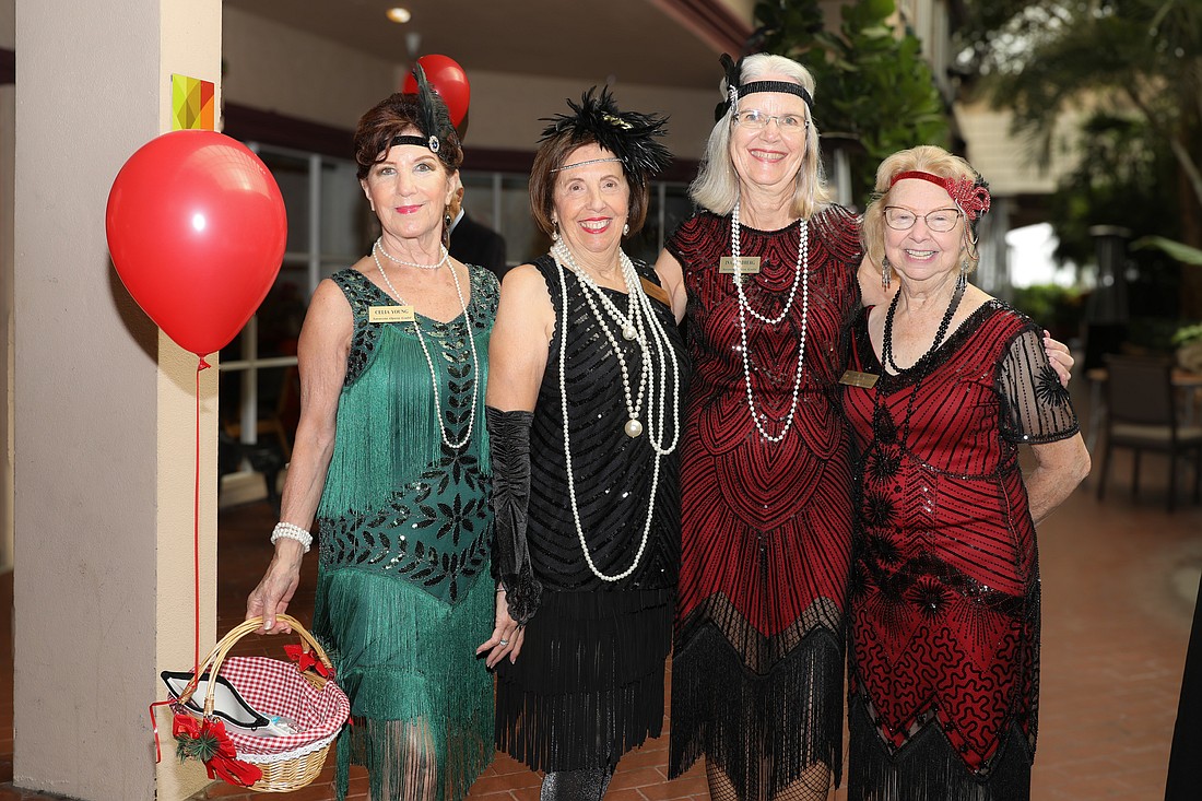 Celia Young, Pat Reinhart, Ina Goldberg and Sherry Wheeler channel their inner flapper style for the Great Gatsby-inspired Poinsettia Luncheon.