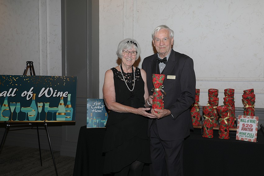 Libbie and Tom Glembocki and the Wall of Wine.