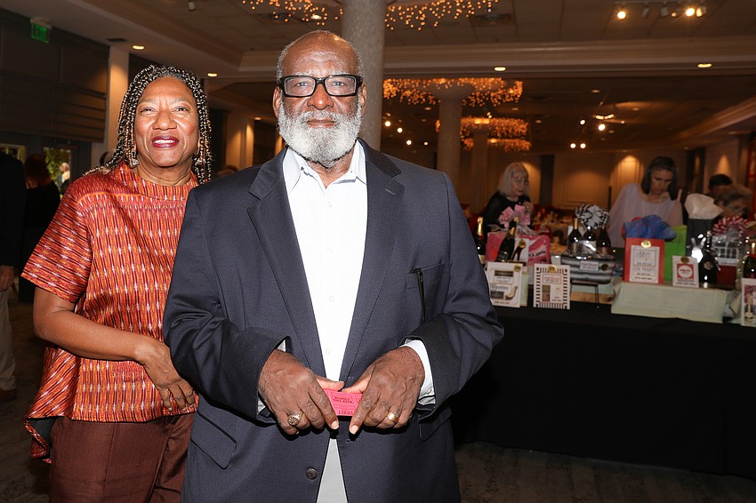 Karen Hunter and Carlton Bennett decide where to put their raffle tickets.