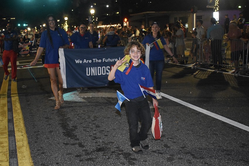 UnidosNow walks with Maximo Abreu, 7, in front.