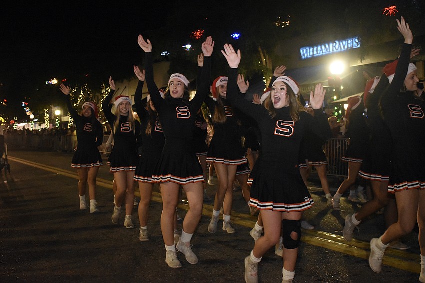 Cheerleaders from Sarasota High School wave to the crowds.
