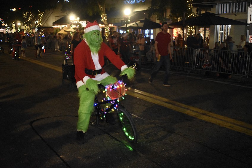 The Grinch approaches on bicycle.