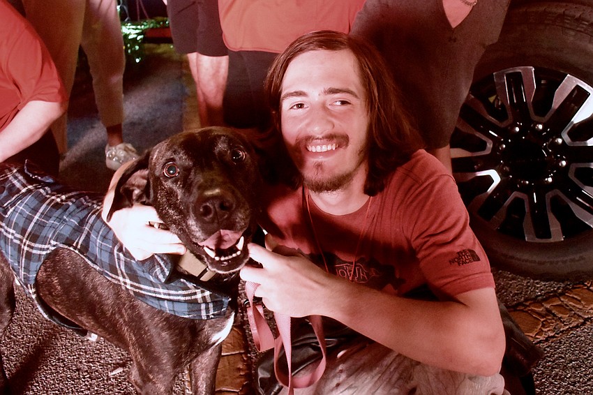 Johnny awaits the start of the parade with Austin Lynch, an animal care enrichment specialist with Humane Society of Sarasota County.