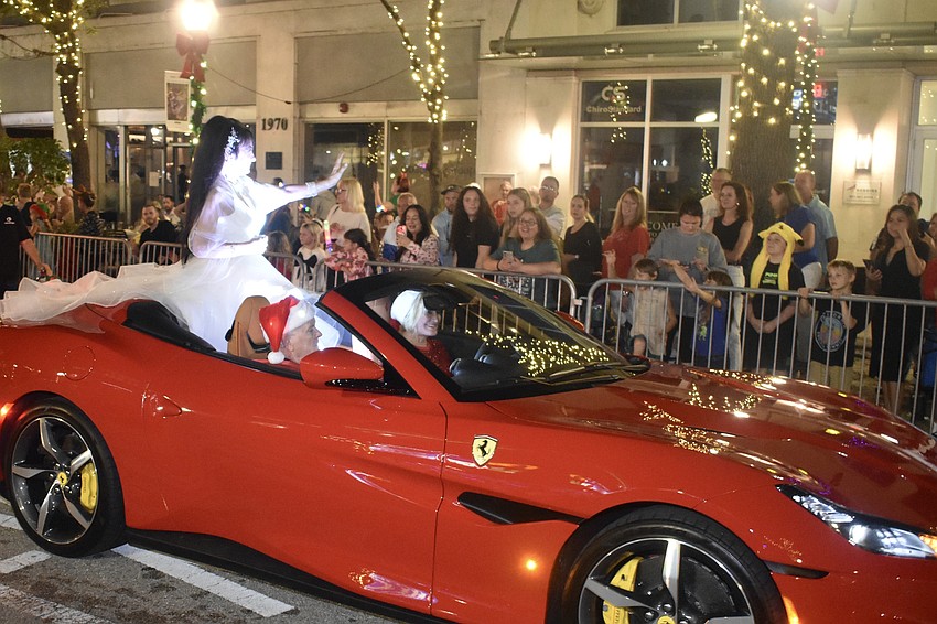 Renowned circus performer Dolly Jacobs waves to viewers, riding with Tom and Linda McDonald.