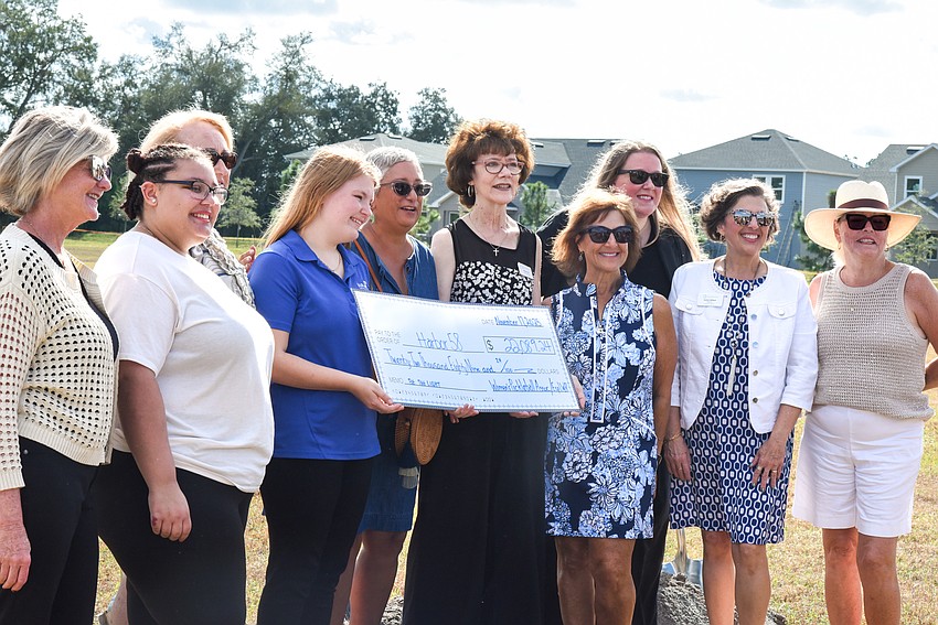 Members of the Esplanade Women’s Pickleball Association present a check to Harbor58 at the groundbreaking ceremony Nov. 17.
