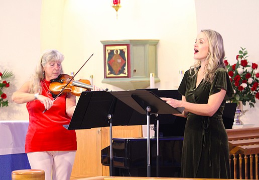 Violinist and pianist Donna Smith performs with singer Johanna Davis at a special Christmas concert for attendees at All Angels by the Sea Episcopal Church on Dec. 6.