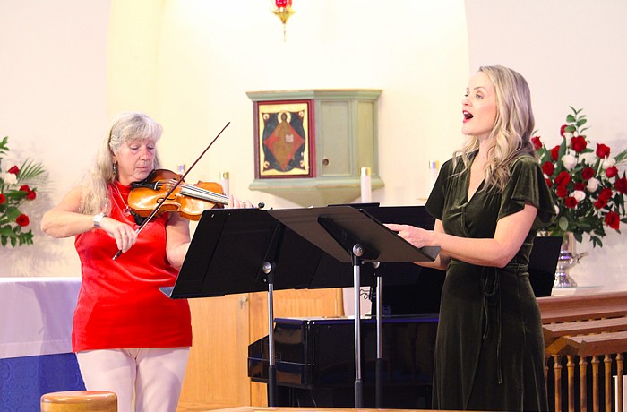 Violinist and pianist Donna Smith performs with singer Johanna Davis at a special Christmas concert for attendees at All Angels by the Sea Episcopal Church on Dec. 6.