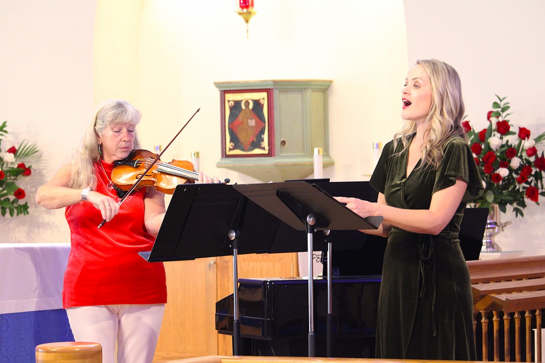 Violinist and pianist Donna Smith performs with singer Johanna Davis at a special Christmas concert for attendees at All Angels by the Sea Episcopal Church on Dec. 6.