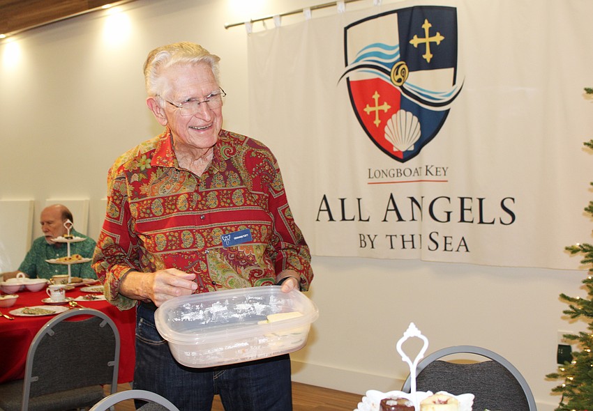 Graham Toft circulates with extra servings of finger foods at the tea time following a Christmas concert Dec. 6 at All Angels by the Sea Episcopal Church.