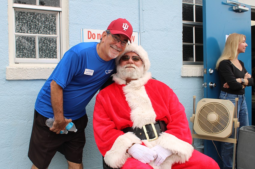Stillpoint Mission President Gary Scott and Santa Claus share a smile at the group's annual holiday festivities on Dec. 6, where families partook in all sorts of seasonal cheer. Scott said this is one event he looks forward to all year.