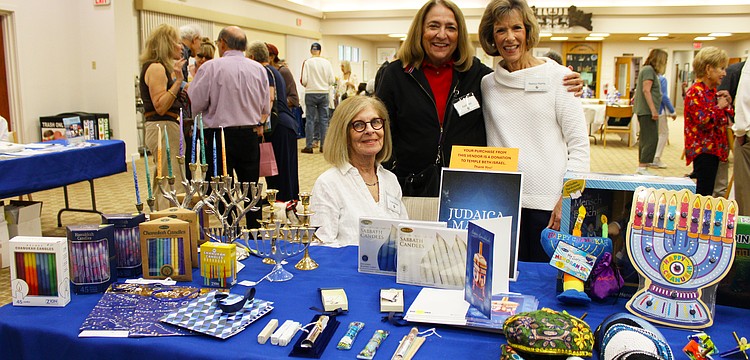 Susan Borden, Kelli Veit and Nancy Harris shared a bit about the goods and games available at Temple Beth Israel's Hanukkah open house on Dec. 7.