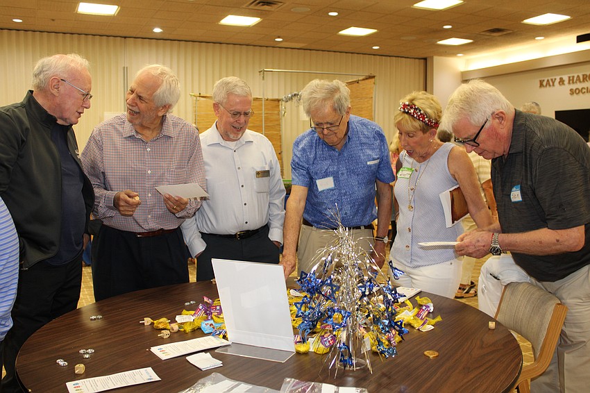 Attendees at the third annual Hanukkah open house on Dec. 7 at Temple Beth Israel took turns trying to win chocolate coins at the dreidel game, just one of many market activities.