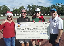 Miracle League Board President Robyn Graham, Elks Golf Tournament Director Mark Liddell, Elk Sarah Davis and Miracle League Executive Director Chris Cushman celebrate the Elks' $1,500 donation to the league.