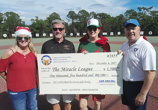 Miracle League Board President Robyn Graham, Elks Golf Tournament Director Mark Liddell, Elk Sarah Davis and Miracle League Executive Director Chris Cushman celebrate the Elks' $1,500 donation to the league.