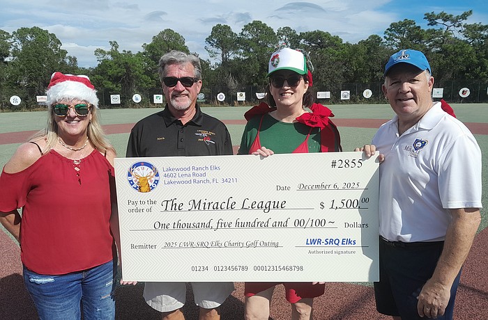Miracle League Board President Robyn Graham, Elks Golf Tournament Director Mark Liddell, Elk Sarah Davis and Miracle League Executive Director Chris Cushman celebrate the Elks' $1,500 donation to the league.