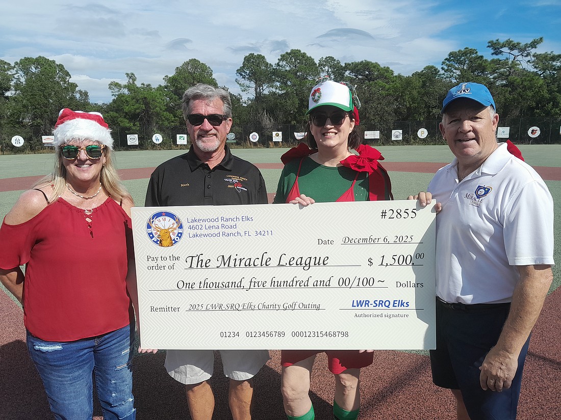 Miracle League Board President Robyn Graham, Elks Golf Tournament Director Mark Liddell, Elk Sarah Davis and Miracle League Executive Director Chris Cushman celebrate the Elks' $1,500 donation to the league.