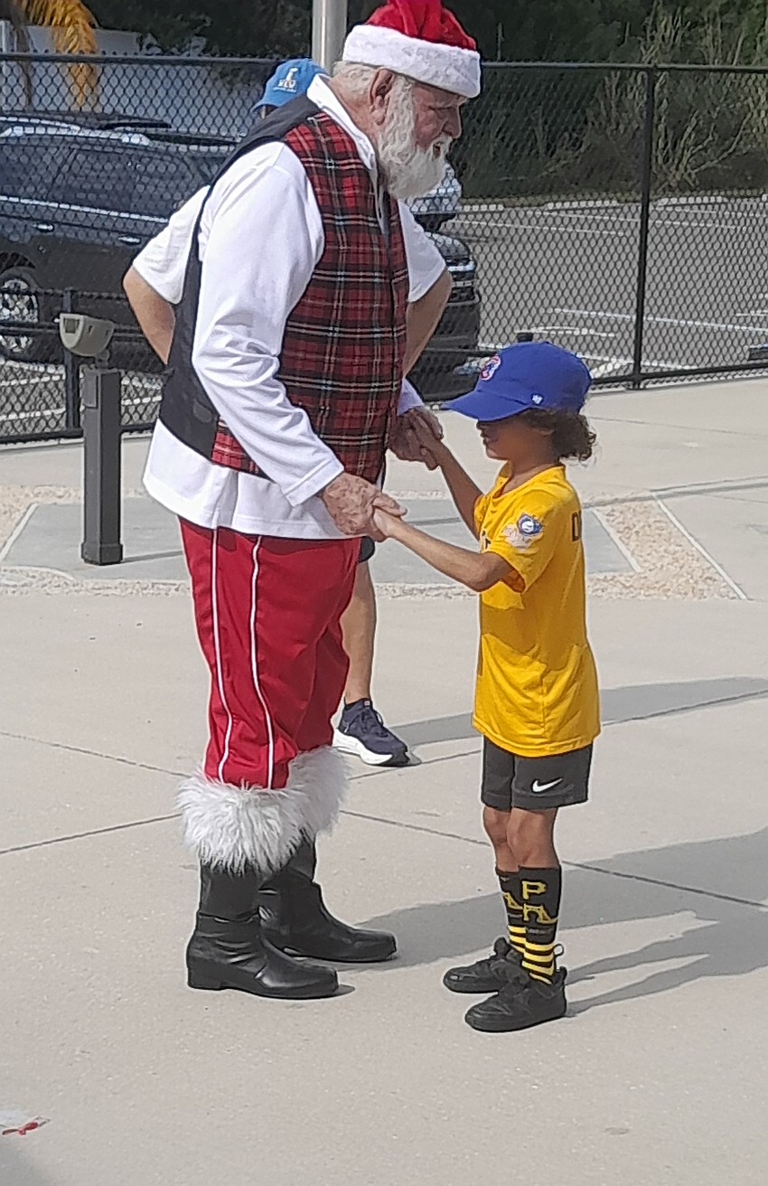 The Elks' Santa (Ron Lee) visits with 8-year-old De'andre McKinon at the Miracle League's first Joanne DiCarlo Christmas Party at Longwood Park. The Elks' Santa (Ron Lee) visits with 8-year-old De'andre McKinon at the Miracle League's first Joanne DiCarlo Christmas Party at Longwood Park.