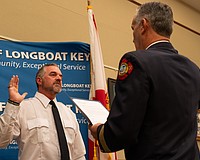 Rev. Brock Patterson raises his right hand as he is sworn in as Longboat Key Fire Rescue’s second ever chaplain at the department’s awards ceremony Thursday, Dec. 4.