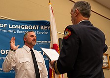 Rev. Brock Patterson raises his right hand as he is sworn in as Longboat Key Fire Rescue’s second ever chaplain at the department’s awards ceremony Thursday, Dec. 4.