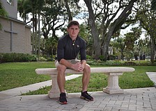 Mason Jordan poses for a photo on Dec. 8 outside the entrance to Cardinal Mooney Catholic High School. The slot receiver is in his fourth and final season on varsity and is the second-leading pass-catcher for the Cougars.