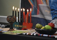 A Kwanzaa display rests on the table during the event.