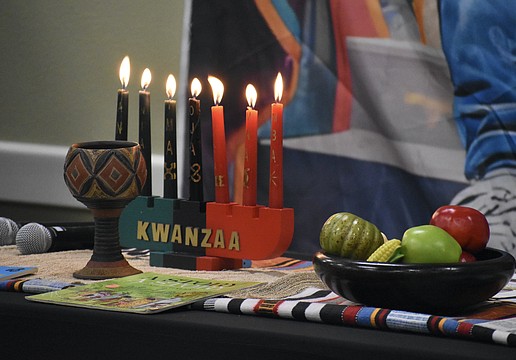 A Kwanzaa display rests on the table during the event.
