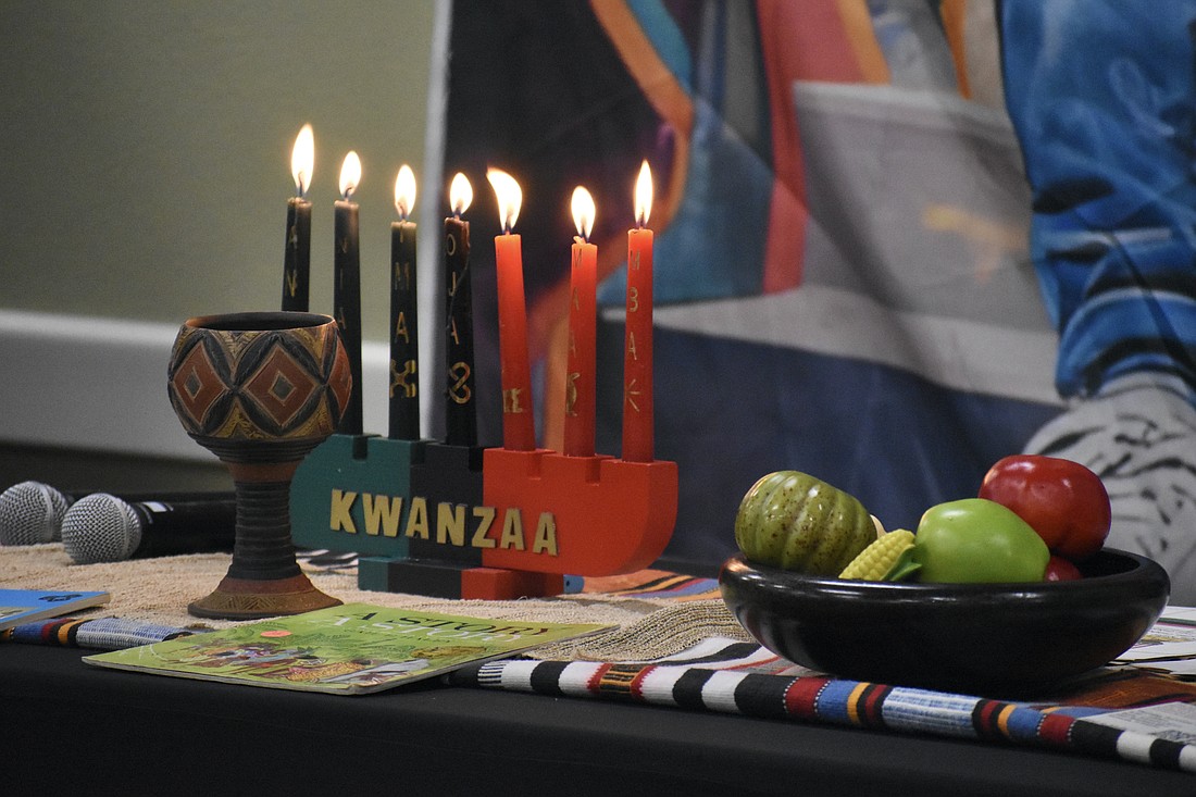 A Kwanzaa display rests on the table during the event.