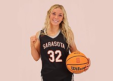 Paisley Binswanger poses for a photo. The four-year varsity player hopes to reach 1,500 points and 300 assists by the time her career with Sarasota High girls basketball concludes in February 2026.