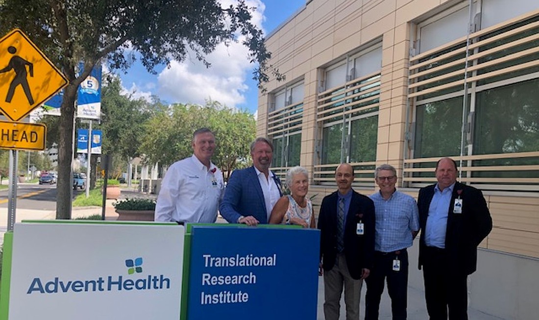 Muffy Runnells with Advent Health Palm Coast Foundation Executive Director John Subers and the team at the AdventHealth Cancer Institute in Orlando. Courtesy photo