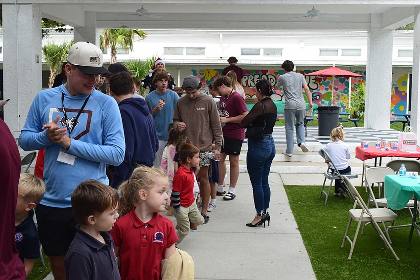 Mentors from Riverview High line up with their Southside Elementary mentees for Rita's Italian Ice. Their celebratory pizza party on Dec. 9 concluded three months of learning, games and building connections.