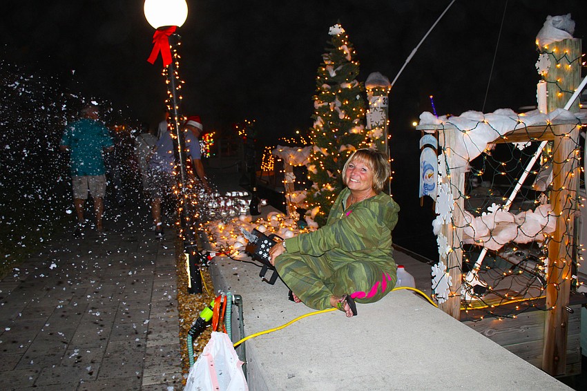 Pat Vecchio catches unsuspecting passersby with snowfall at the Lighting of the Docks on Dec. 6 at Longboat Harbour.