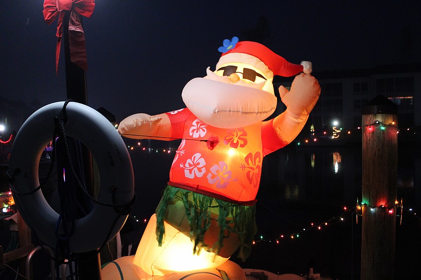 Santa Claus surfs into the holiday season off Longboat Harbour on Dec. 6 at the Lighting of the Docks.