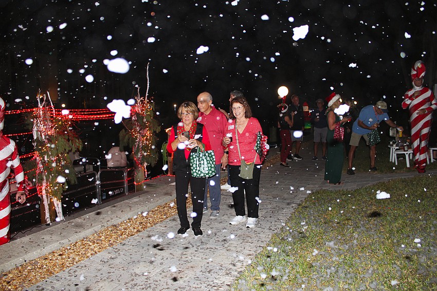 Fran Risley and Carol and John Bruno witness snow on Longboat Key during the Lighting of the Docks.