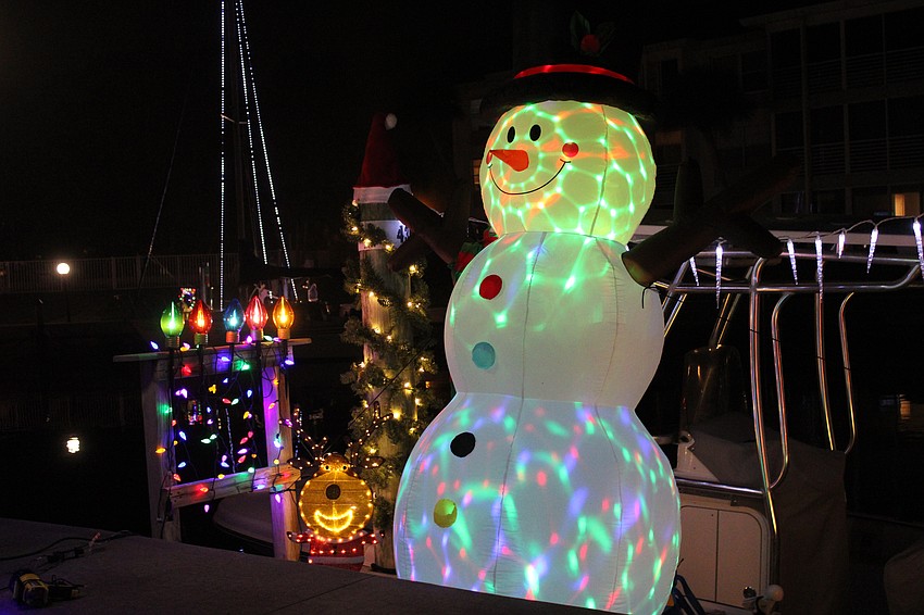 Frosty adds to the glow of Longboat Harbour at the Lighting of the Docks.