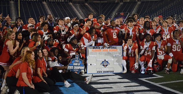 Cardinal Mooney football gathers at midfield and poses for a photo. The Cougars scored on every single one of their drives in the FHSAA Class 2A state championship, piling up 52 points against the Bulldogs.