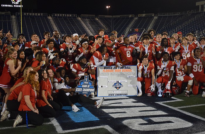 Cardinal Mooney football gathers at midfield and poses for a photo. The Cougars scored on every single one of their drives in the FHSAA Class 2A state championship, piling up 52 points against the Bulldogs.