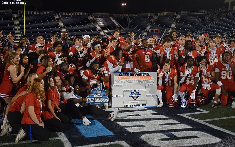 Cardinal Mooney football gathers at midfield and poses for a photo. The Cougars scored on every single one of their drives in the FHSAA Class 2A state championship, piling up 52 points against the Bulldogs.