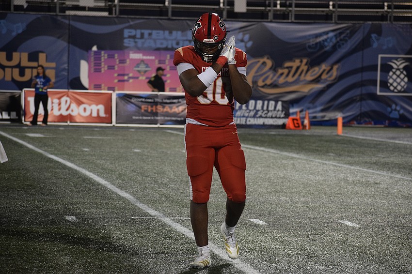 Elijah Golden does a sleep gesture after a sack late in the fourth quarter, with the Cougars' victory sealed. The senior defensive end helped Cardinal Mooney hold Bolles to seven points in the first half en route to becoming a state champion.