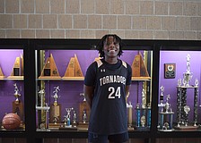 Yvette Brown poses for a photo on Dec. 11 next to the trophy case by Booker's gym. Through the first six games of the Tornadoes' season, she led in points, rebounds and steals.