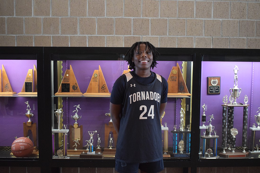 Yvette Brown poses for a photo on Dec. 11 next to the trophy case by Booker's gym. Through the first six games of the Tornadoes' season, she led in points, rebounds and steals.