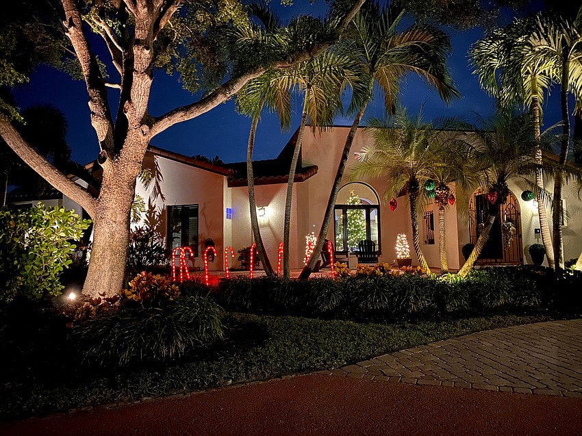 A beautiful candy cane lane lines the footpath of the house on the corner of Bird Key Drive and W. Royal Flamingo Drive.