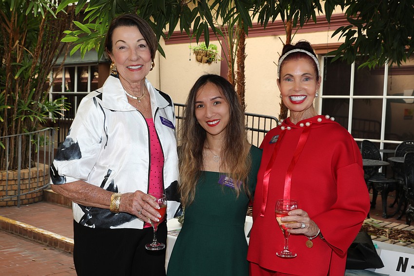 Greeting luncheon guests are Bonnie VanOverbeke, Ning Tinsley and Katherine Pike.