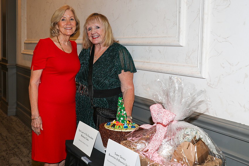 Looking after the live auction pastry items are Mary Mandl and Debbie Grossman.