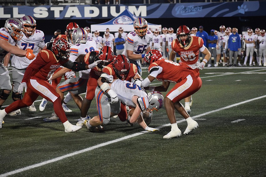 A pack of Cardinal Mooney tacklers swarm Bolles running back Xander Edwards. The Florida Gatorade Player of the Year finalist failed to record a touchdown in a game for the first time all season.