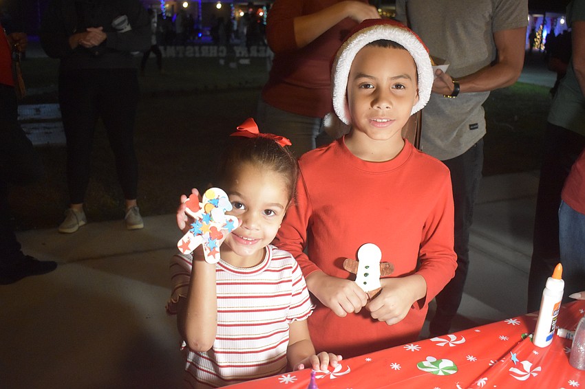 Jadelys Solorzano, 4 and Maximuz Duprey, 8, show off their gingerbread men crafts they made at River Wonderland.