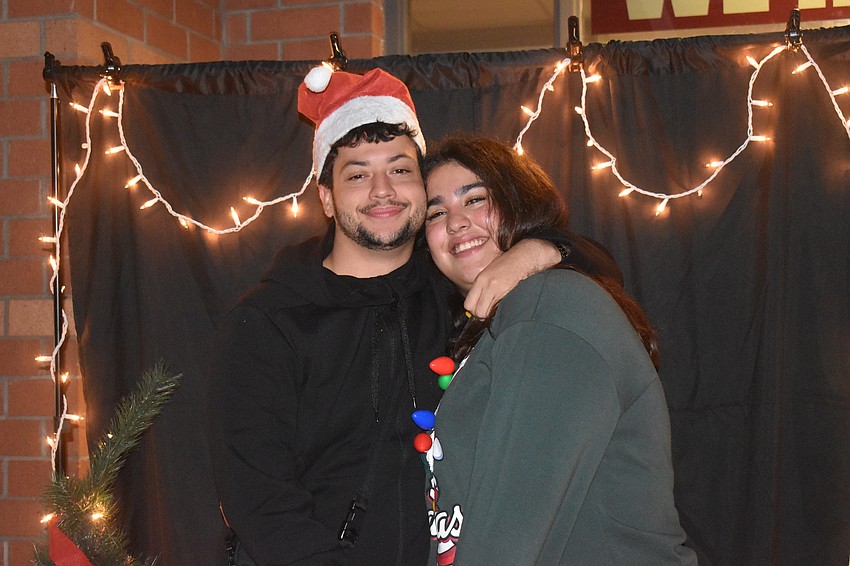 Ryan Barr and Valeria Garcia, a senior at Braden River, pose for a photo in front of the many backdrops available at River Wonderland.