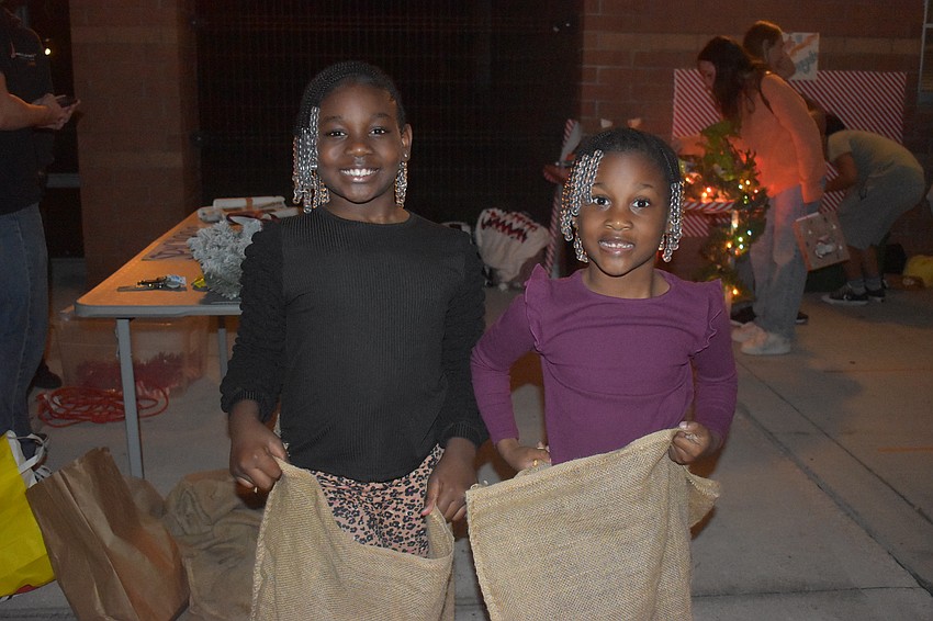 Bradenton's Gigi Bryan, 8 and Gabbi Bryan, 6 prepare to jump in potato sacks through an obstacle course at River Wonderland.