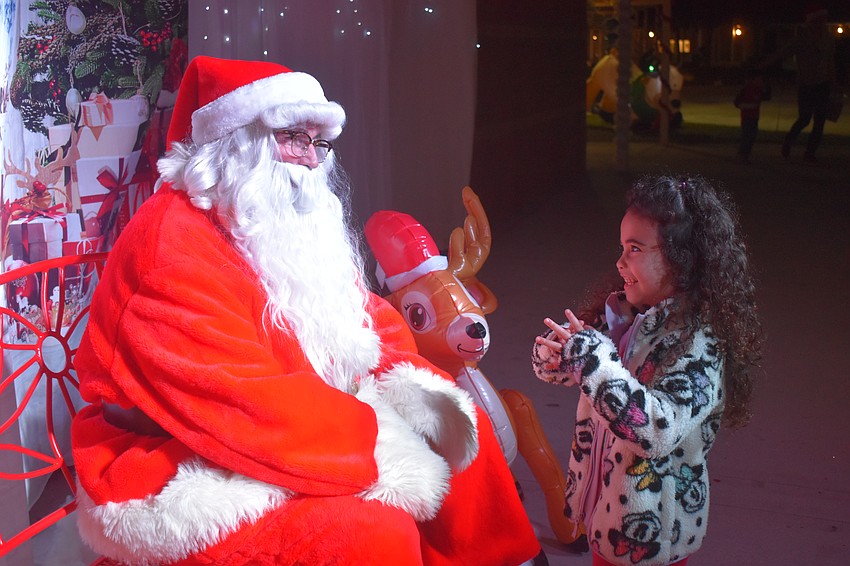 Jiyabella Abraham, 5, is eager to talk to Santa. She says she didn't want to request certain gifts, but wanted Santa to pick out what he thinks she would like.